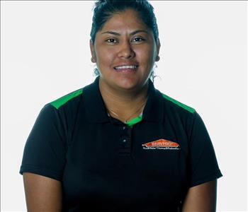 Woman in SERVPRO uniform posing for a picture on a white background