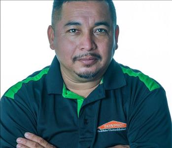 Man in SERVPRO uniform posing for a picture on a white background