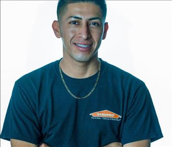 Man in SERVPRO uniform posing for a picture on a white background