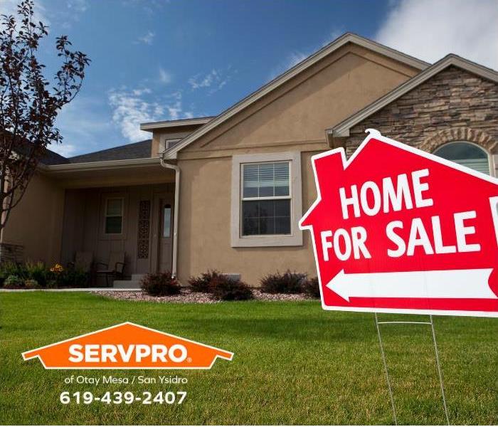 A home has a for sale sign in the front yard. 