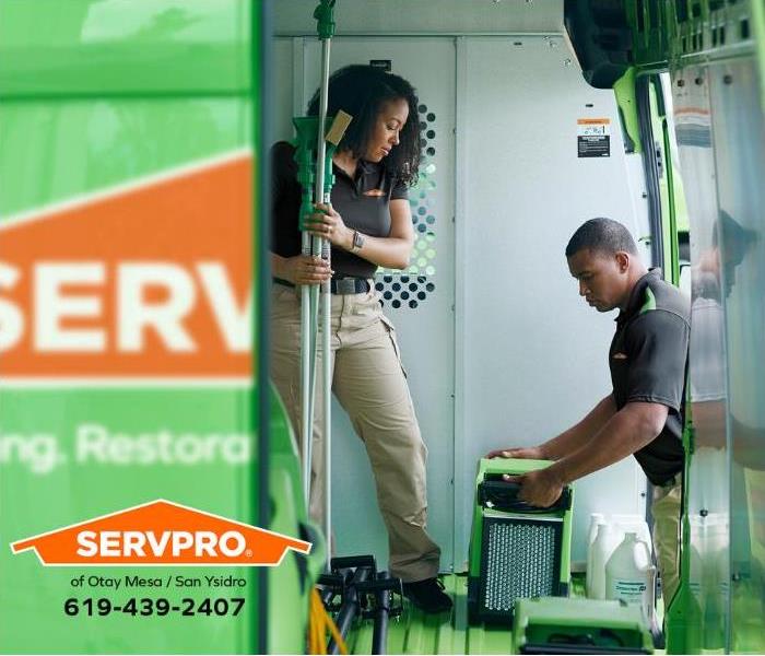 SERVPRO technicians are loading equipment onto a service vehicle.