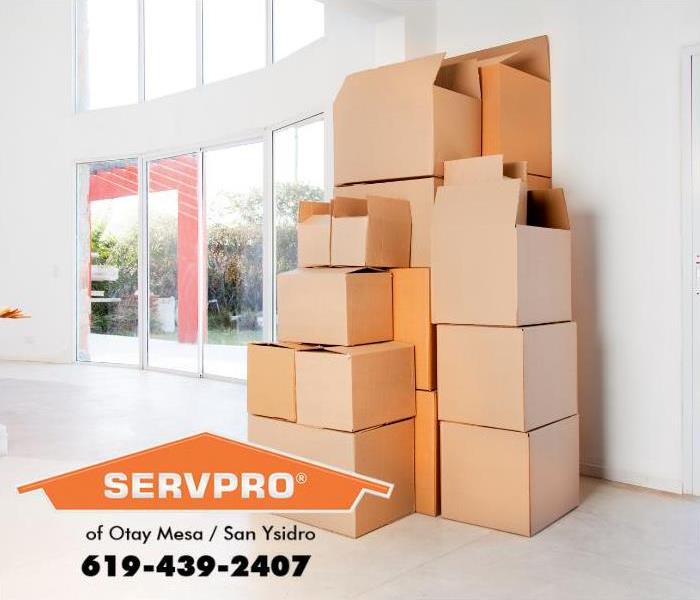 A stack of moving boxes are shown inside a house.