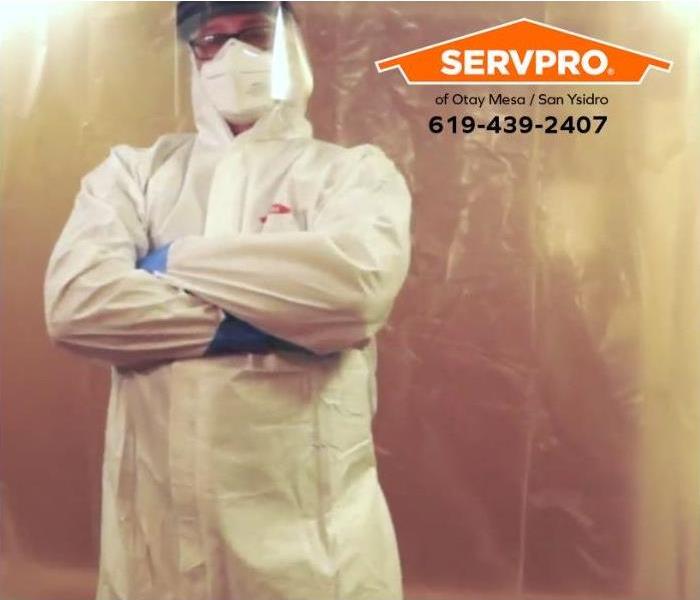 A technician stands in front of a mold containment chamber.