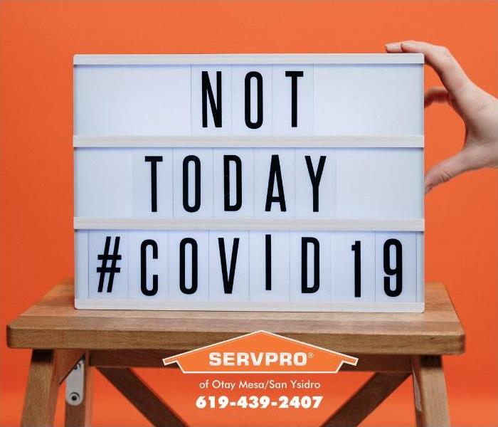 A sign sits on an easel proclaiming, “Not Today COVID-19.”