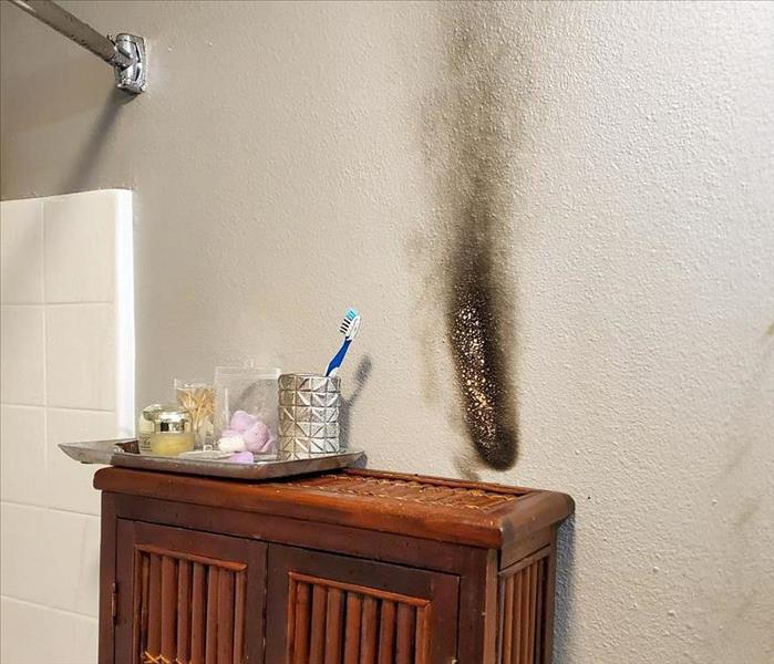 Fire and smoke damage on the wall of an Otay Mesa home from a candle.